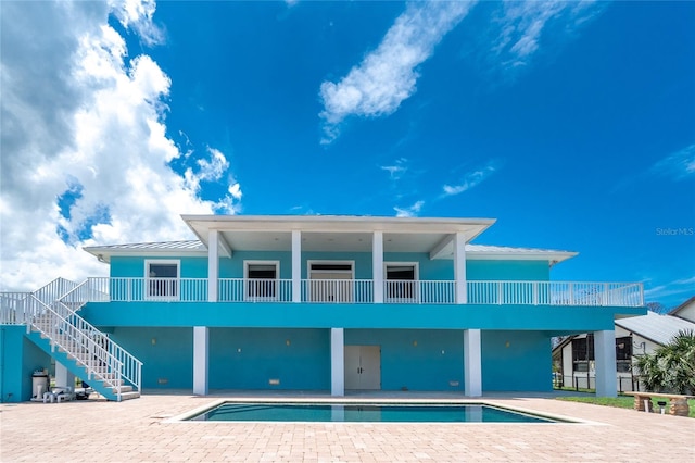 1930 Massachusetts Ave, Englewood, FL 34224 - back of house with a patio, an outdoor pool, and stairway