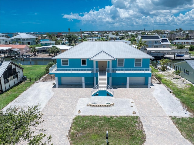 1930 Massachusetts Ave, Englewood, FL 34224 - coastal inspired home with stairs, an attached garage, and decorative driveway