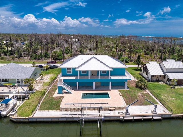 1930 Massachusetts Ave, Englewood, FL 34224 - rear view of house featuring an outdoor pool, a water view, a patio, and a lawn