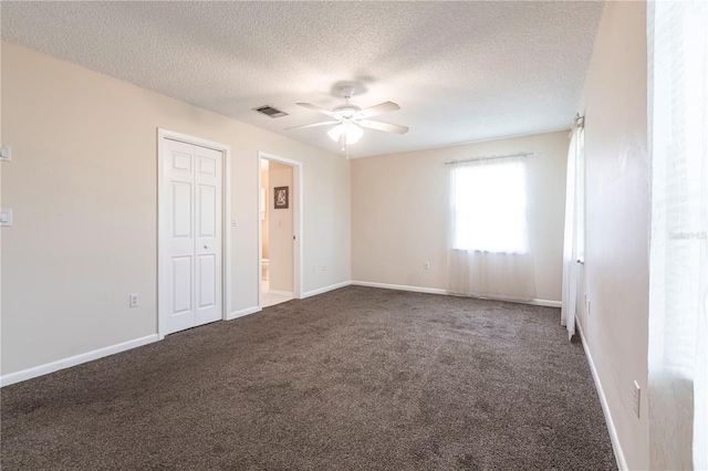 3085 Crowder St, Punta Gorda, FL 33980 - unfurnished bedroom with dark colored carpet, a textured ceiling, a closet, and a ceiling fan