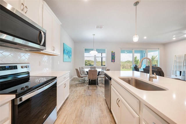 17921 Grand Prosperity Dr, Venice, FL 34293 - kitchen with appliances with stainless steel finishes, decorative backsplash, open floor plan, light countertops, and recessed lighting