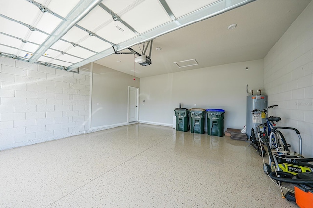 17921 Grand Prosperity Dr, Venice, FL 34293 - garage with gas water heater, concrete block wall, and a garage door opener