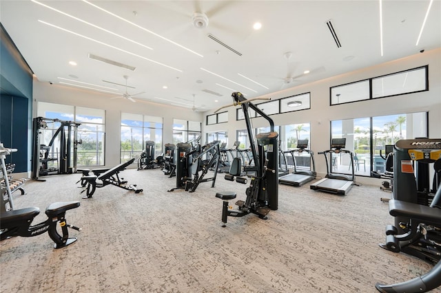 17921 Grand Prosperity Dr, Venice, FL 34293 - gym with carpet floors, a ceiling fan, a towering ceiling, and recessed lighting