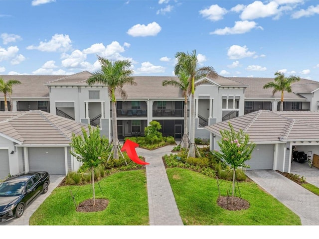 12550 Galapagos Ct Unit 104, Venice, FL 34293 - multi unit property featuring a tiled roof, a front yard, and stucco siding