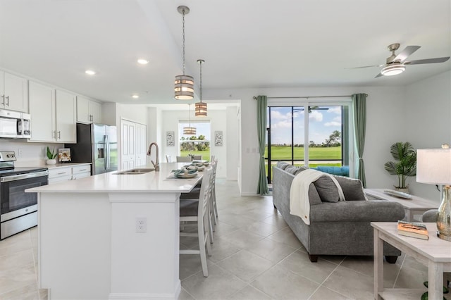 12550 Galapagos Ct Unit 104, Venice, FL 34293 - kitchen with appliances with stainless steel finishes, open floor plan, recessed lighting, light countertops, and white cabinets