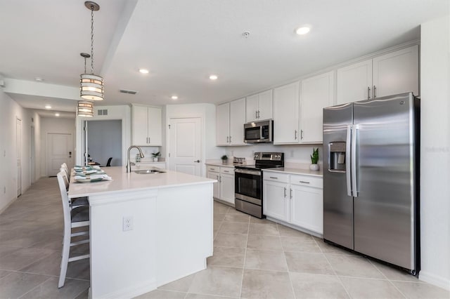 12550 Galapagos Ct Unit 104, Venice, FL 34293 - kitchen with appliances with stainless steel finishes, light tile patterned flooring, white cabinetry, recessed lighting, and light countertops