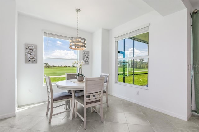 12550 Galapagos Ct Unit 104, Venice, FL 34293 - dining room featuring a chandelier, light tile patterned floors, and golf course view