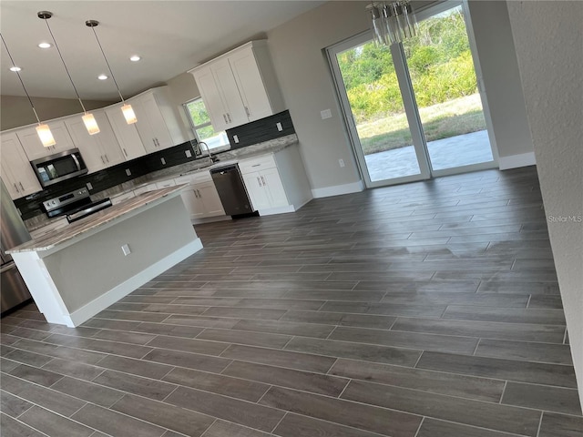 329 Overbrook St, Port Charlotte, FL 33954 - kitchen with appliances with stainless steel finishes, backsplash, dark wood finished floors, recessed lighting, and white cabinets