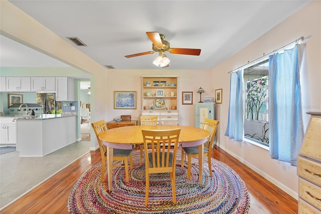 7690 Castleberry Ter, Englewood, FL 34224 - dining area featuring wood finished floors and ceiling fan