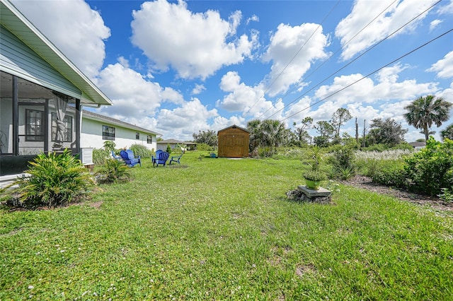 7690 Castleberry Ter, Englewood, FL 34224 - view of green lawn with a shed and a sunroom