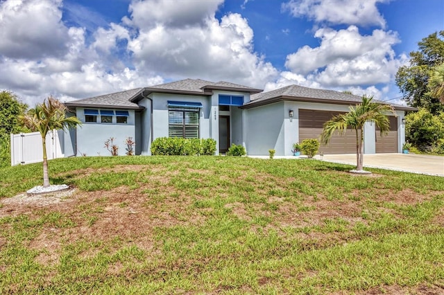 1269 N Lavina St, North Port, FL 34286 - prairie-style house featuring an attached garage, driveway, and stucco siding