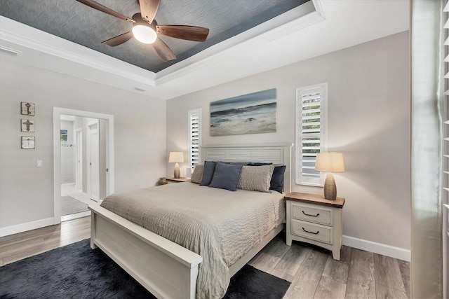 1269 N Lavina St, North Port, FL 34286 - bedroom featuring a raised ceiling, wood finished floors, crown molding, and ceiling fan