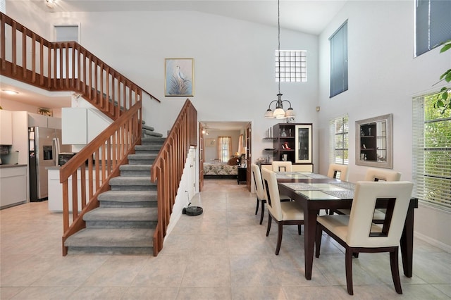 196 Lecturn St, Port Charlotte, FL 33954 - dining area featuring a chandelier, stairway, high vaulted ceiling, and light tile patterned flooring