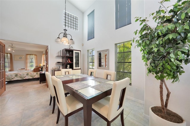 196 Lecturn St, Port Charlotte, FL 33954 - dining space featuring ceiling fan, light tile patterned floors, a high ceiling, and a chandelier