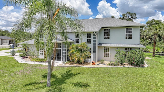 196 Lecturn St, Port Charlotte, FL 33954 - view of front of property featuring stucco siding, a front yard, and roof with shingles