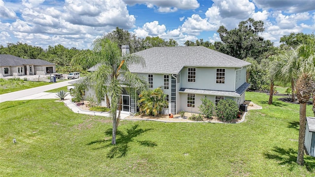 196 Lecturn St, Port Charlotte, FL 33954 - view of front of home featuring stucco siding, a chimney, a front yard, and a shingled roof
