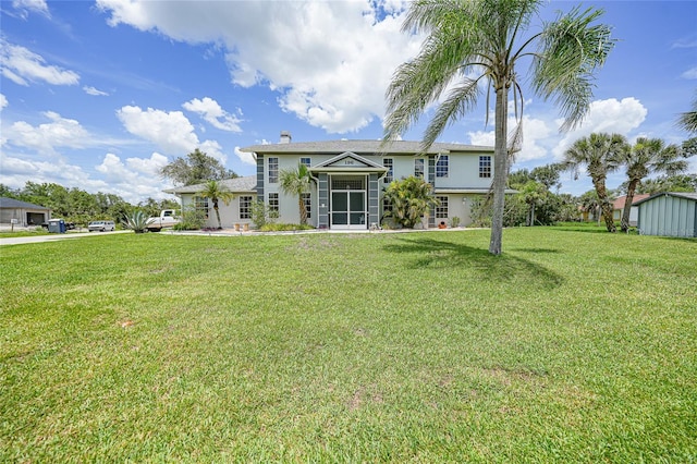 196 Lecturn St, Port Charlotte, FL 33954 - rear view of house with a lawn