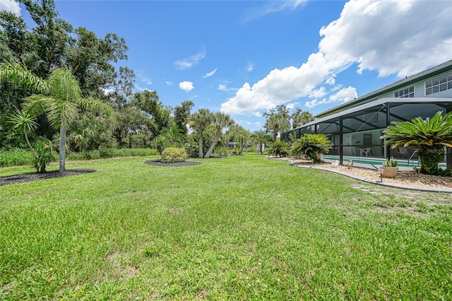 196 Lecturn St, Port Charlotte, FL 33954 - view of grassy yard featuring glass enclosure and an outdoor pool