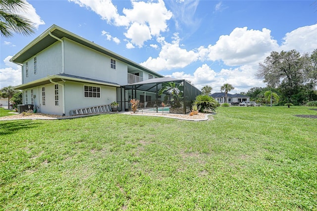 196 Lecturn St, Port Charlotte, FL 33954 - rear view of house with stucco siding, a lawn, a lanai, and an outdoor pool