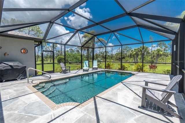 1119 Boundary Blvd, Rotonda West, FL 33947 - outdoor pool featuring a patio area, grilling area, glass enclosure, and view of wooded area