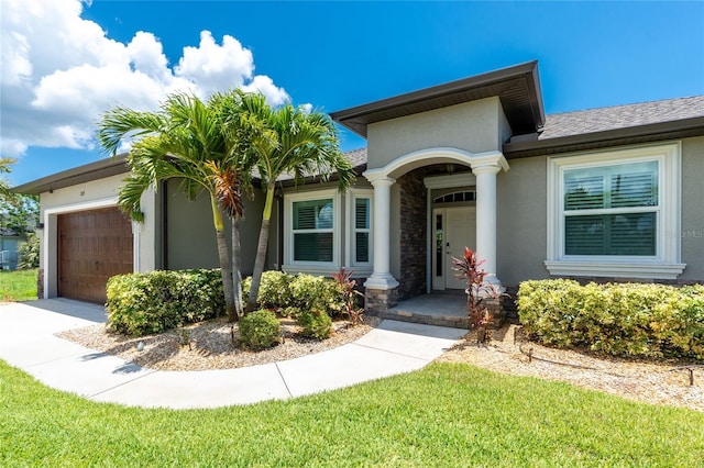 1119 Boundary Blvd, Rotonda West, FL 33947 - view of front of property featuring stucco siding, an attached garage, stone siding, and concrete driveway
