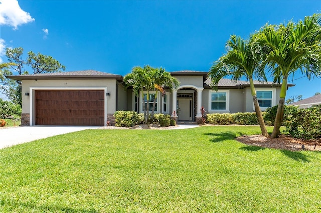 1119 Boundary Blvd, Rotonda West, FL 33947 - view of front of property with a garage, stucco siding, driveway, and a front lawn