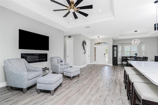 1119 Boundary Blvd, Rotonda West, FL 33947 - living room with a raised ceiling, light wood-style flooring, a ceiling fan, recessed lighting, and crown molding