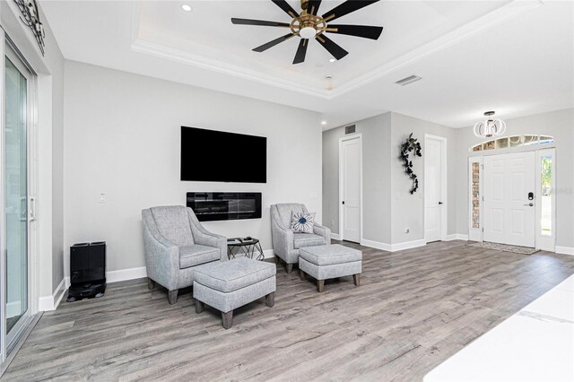 1119 Boundary Blvd, Rotonda West, FL 33947 - sitting room with a tray ceiling, light wood-style floors, recessed lighting, a ceiling fan, and ornamental molding