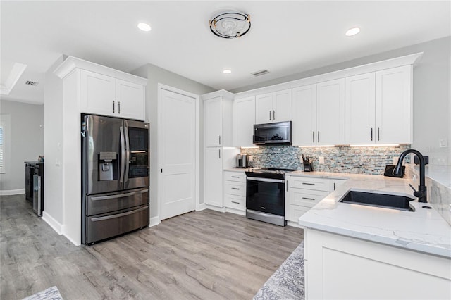 1119 Boundary Blvd, Rotonda West, FL 33947 - kitchen with stainless steel appliances, light stone countertops, backsplash, light wood-style flooring, and recessed lighting