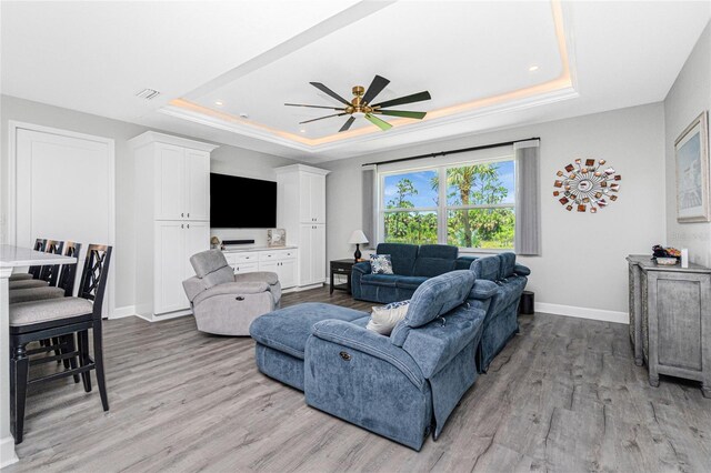 1119 Boundary Blvd, Rotonda West, FL 33947 - living area featuring a raised ceiling, light wood-style floors, a ceiling fan, and recessed lighting