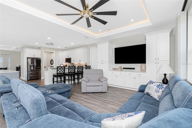 1119 Boundary Blvd, Rotonda West, FL 33947 - living room featuring a tray ceiling, a ceiling fan, light wood-style flooring, recessed lighting, and crown molding