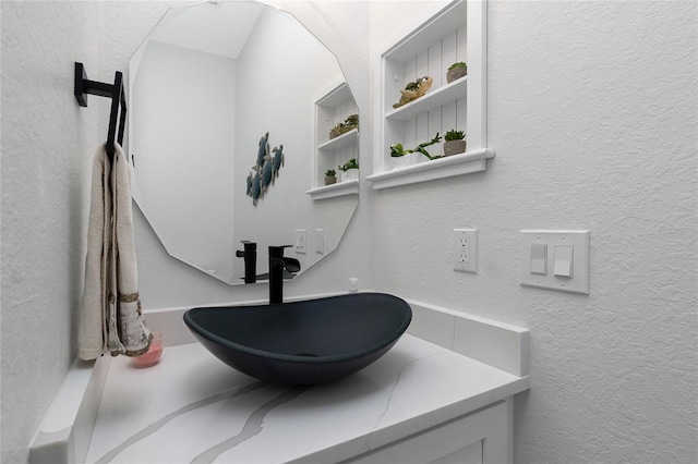 1119 Boundary Blvd, Rotonda West, FL 33947 - bathroom with a textured wall and vanity