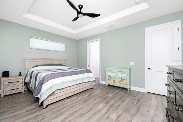 1119 Boundary Blvd, Rotonda West, FL 33947 - bedroom with a raised ceiling, ornamental molding, wood finished floors, and ceiling fan