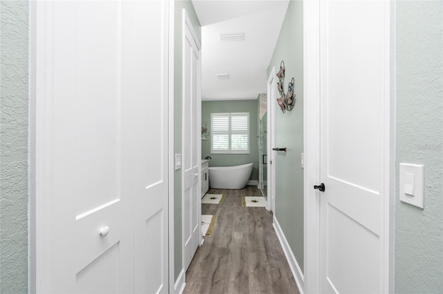 1119 Boundary Blvd, Rotonda West, FL 33947 - hallway featuring wood finished floors and a textured wall