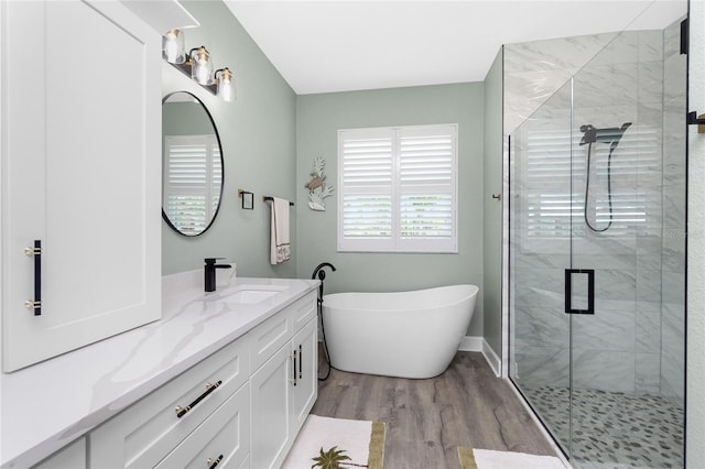1119 Boundary Blvd, Rotonda West, FL 33947 - bathroom with vanity, a freestanding tub, a stall shower, and wood finished floors