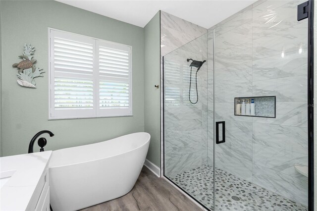 1119 Boundary Blvd, Rotonda West, FL 33947 - full bath with a soaking tub, a stall shower, wood finished floors, and vanity