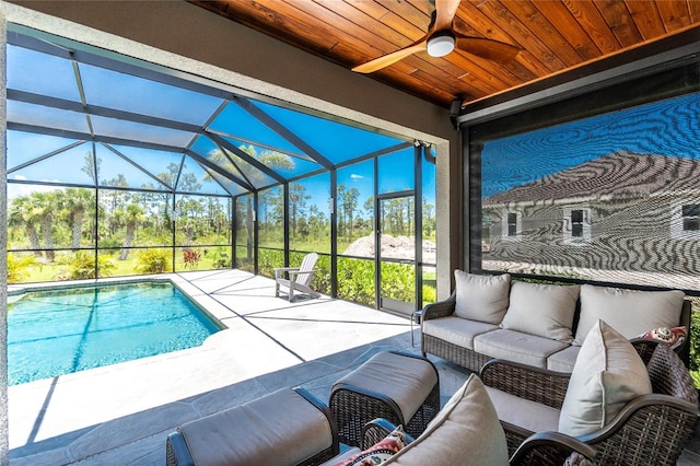 1119 Boundary Blvd, Rotonda West, FL 33947 - view of patio / terrace with an outdoor living space, a ceiling fan, an outdoor pool, and a lanai