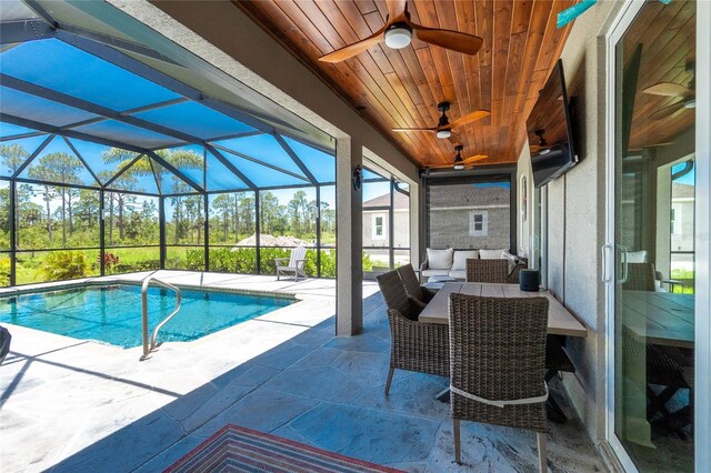 1119 Boundary Blvd, Rotonda West, FL 33947 - swimming pool with a ceiling fan, outdoor lounge area, a patio, and glass enclosure