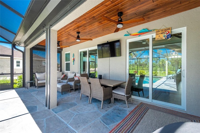 1119 Boundary Blvd, Rotonda West, FL 33947 - view of patio with a ceiling fan, glass enclosure, an outdoor pool, and an outdoor living space