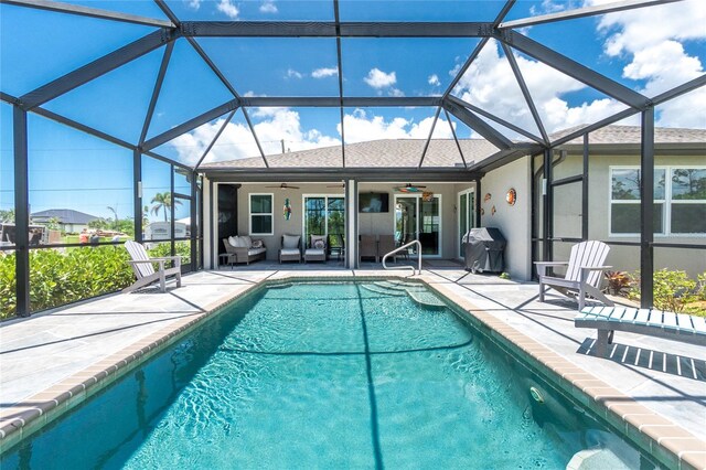 1119 Boundary Blvd, Rotonda West, FL 33947 - outdoor pool featuring ceiling fan, a patio area, an outdoor living space, glass enclosure, and grilling area