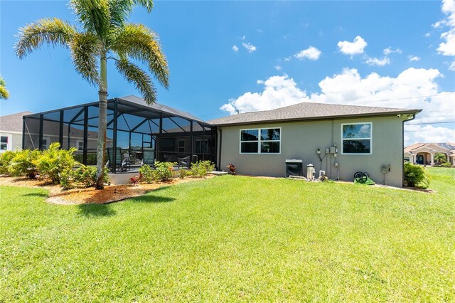 1119 Boundary Blvd, Rotonda West, FL 33947 - back of house with stucco siding, a lawn, and a lanai