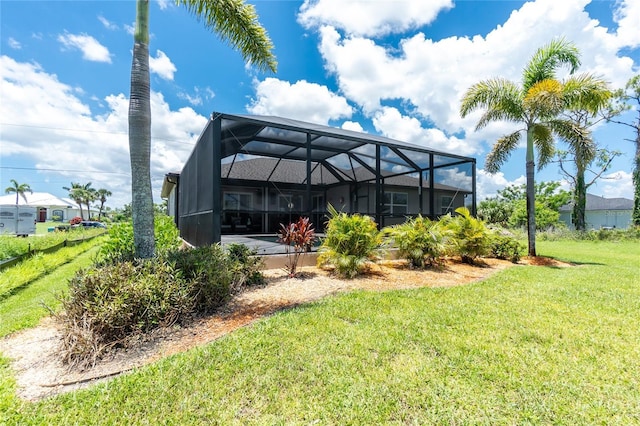 1119 Boundary Blvd, Rotonda West, FL 33947 - rear view of property featuring a lawn and a lanai