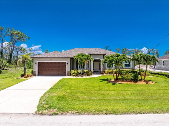 1119 Boundary Blvd, Rotonda West, FL 33947 - single story home with stucco siding, an attached garage, a front lawn, and driveway