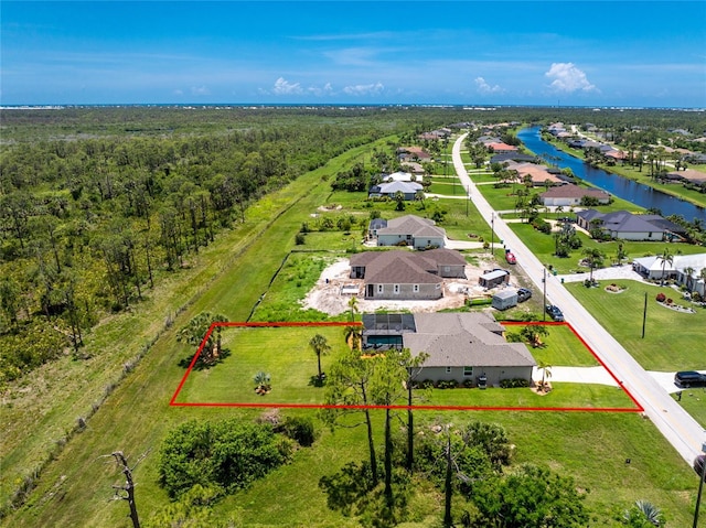 1119 Boundary Blvd, Rotonda West, FL 33947 - aerial perspective of suburban area featuring property parcel outlined and a nearby body of water