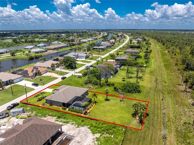 1119 Boundary Blvd, Rotonda West, FL 33947 - aerial perspective of suburban area featuring property boundaries highlighted and a large body of water