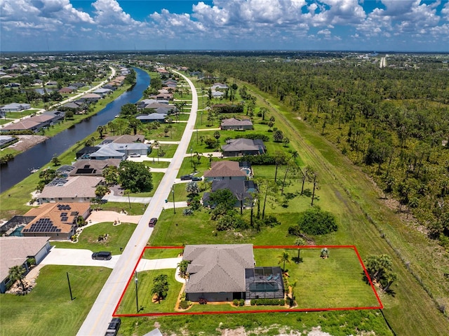 1119 Boundary Blvd, Rotonda West, FL 33947 - aerial view of residential area with property parcel outlined and a nearby body of water