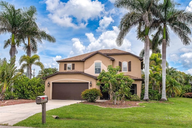 26294 Bridgewater Rd, Punta Gorda, FL 33983 - mediterranean / spanish-style home featuring stucco siding, driveway, a garage, and a front lawn
