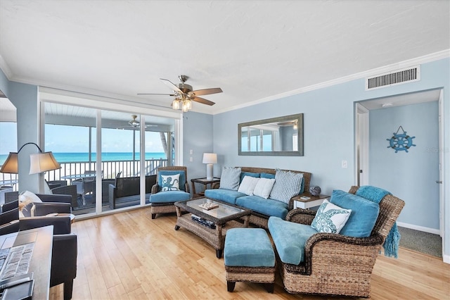7554 Palm Island Dr S Unit 1813, Placida, FL 33946 - living area featuring a ceiling fan, light wood-type flooring, crown molding, and a water view