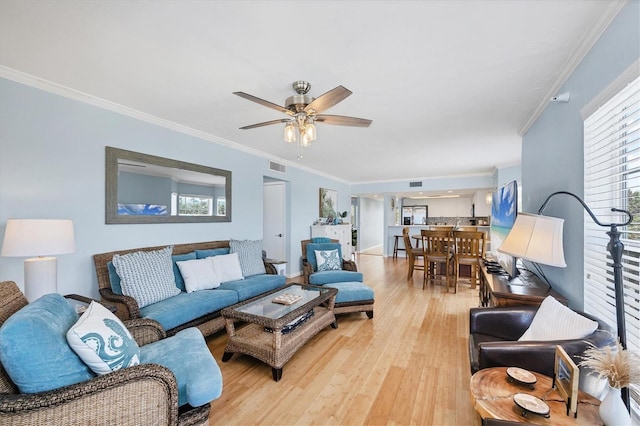 7554 Palm Island Dr S Unit 1813, Placida, FL 33946 - living room with light wood-style flooring, a ceiling fan, and ornamental molding
