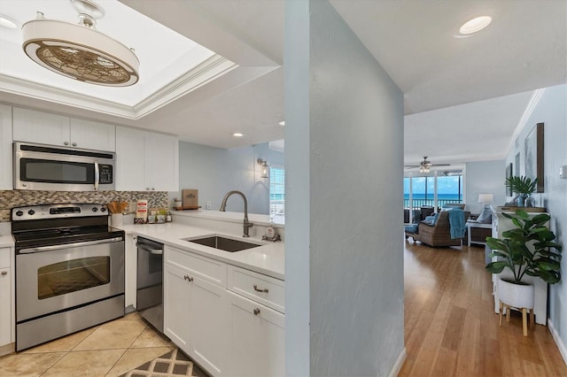 7554 Palm Island Dr S Unit 1813, Placida, FL 33946 - kitchen featuring stainless steel appliances, decorative backsplash, light countertops, white cabinets, and open floor plan